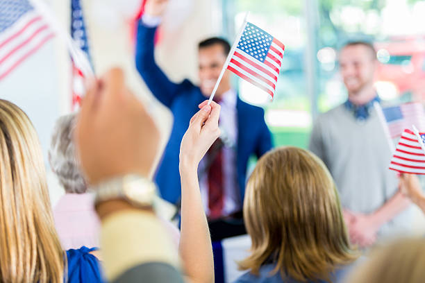 istock Crowd waving flags, celebrating candidate's success during election 601923246