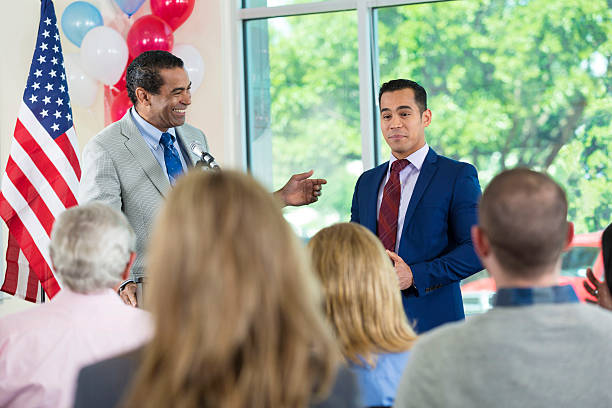 istock Senior politician introducing local political candidate before speech 601923296