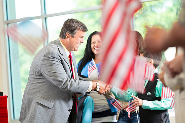 istock Local politician shaking hands and greeting supporters at event 601923442