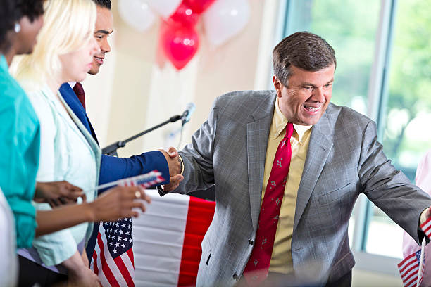istock Local politician shaking hands with supporters at event 601923444