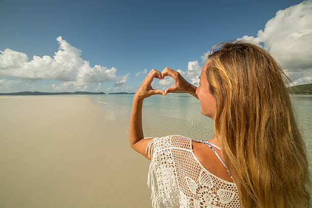 istock Young woman at Hill Inlet makes heart shape finger frame 601923652