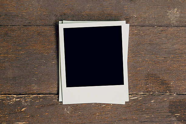 istock Vintage photo frame blank on old wood background with space 601924292