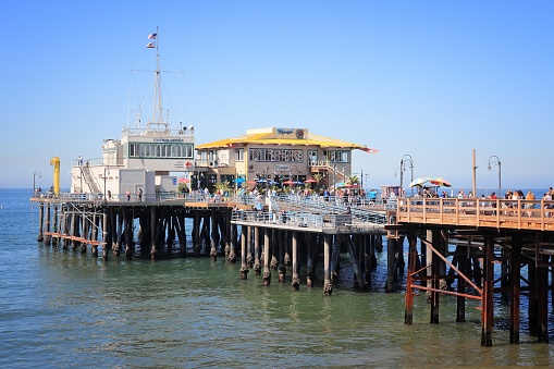 Santa Monica, California - April 6, 2014: People visit the pier in Santa Monica, California. As of 2012 more than 7 million visitors from outside of LA county visited Santa Monica annually.