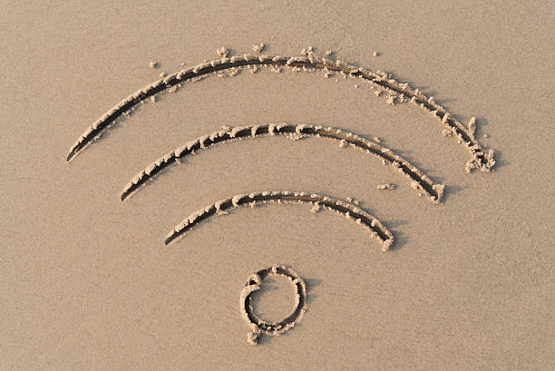 wifi sign on sand beach stock photo