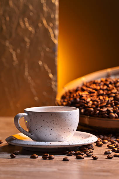 Cup of black coffee and roasted beans