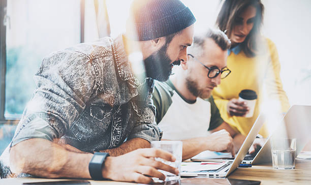 istock Group Young Business People Gathered Together Discussing Creative Idea Cafe 601928026