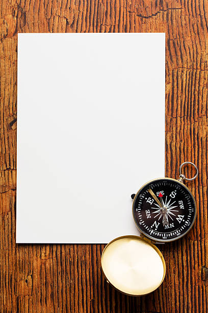 istock Compass and blank note on a wooden background 601930422
