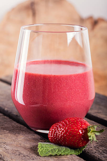 istock Glass with strawberry cocktail on wooden plank 601932032