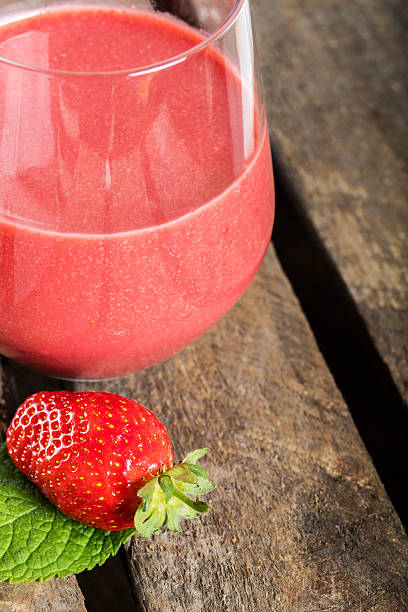 istock Glass with strawberry cocktail on wooden plank 601932242