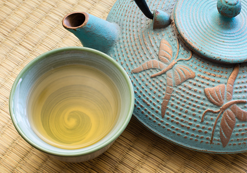 Oriental cast iron tea pot with cup