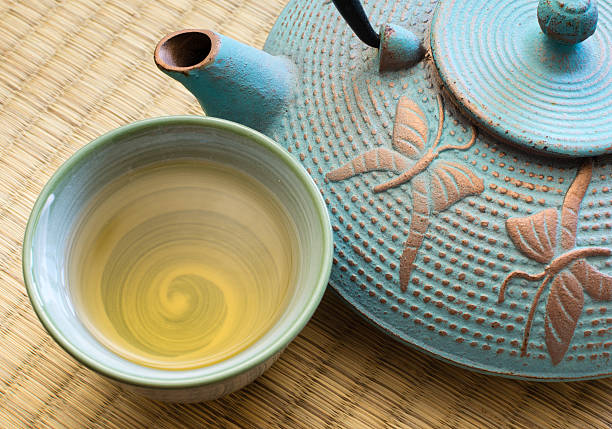 oriental cast iron tea pot with cup - tatami mat bildbanksfoton och bilder