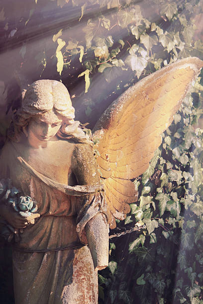 istock golden angel in the sunlight (antique statue) 601933402