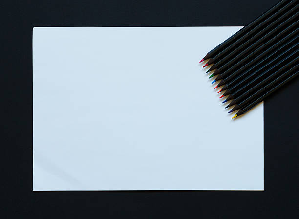 istock Blank paper and colorful pencils on black 601934970