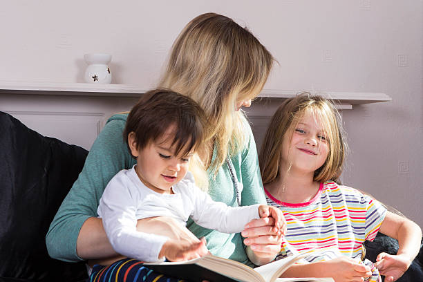 istock Mother reading to kids in bed 601935908
