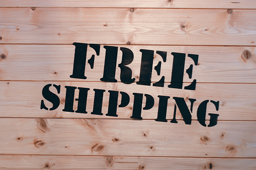 Free Shipping. Free Shipping word on wooden transport box.