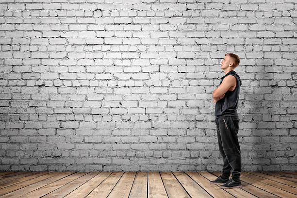 istock Front view of muscled young man looking up 601938964