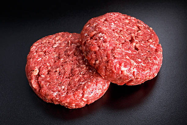 istock Home HandMade Raw Minced Beef steak burgers on black board 601941240