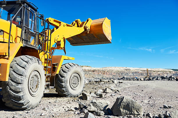 istock wheel loader excavator at granite or iron ore opencast mine 601941266