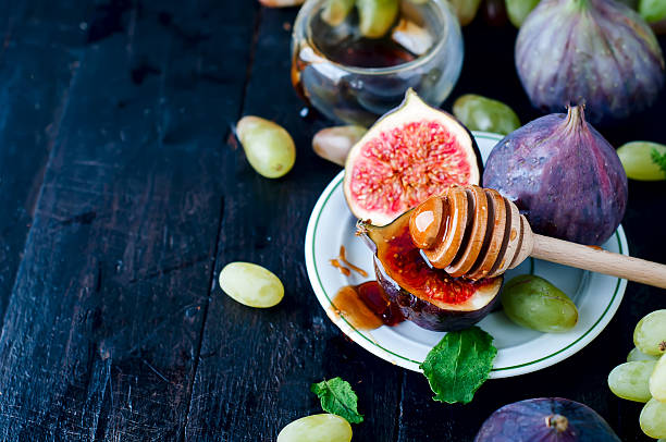 istock figs and honey on wooden table background. 601942906