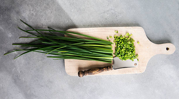 Chopped chives on cutting board stock photo