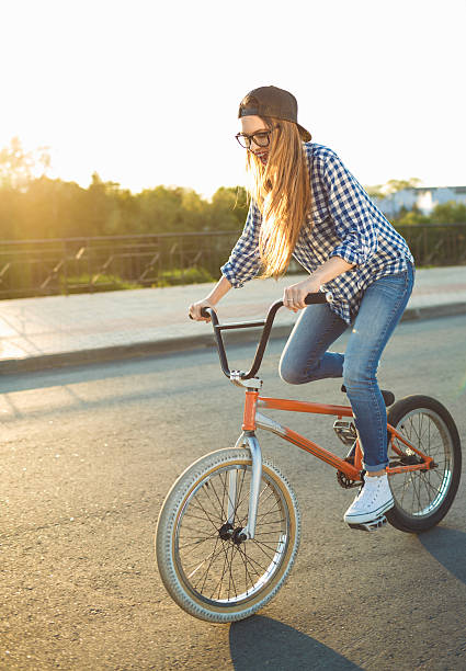 istock Lovely young woman in a hat riding a bicycle 601943676