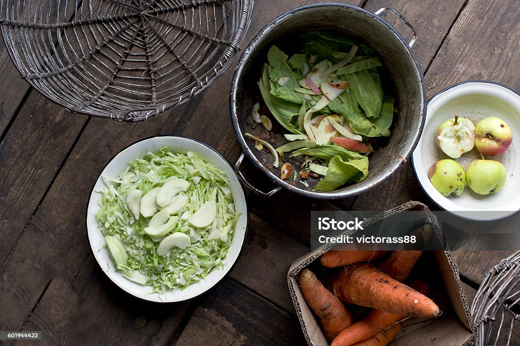 Peel And Chop Vegetables Peeling and chopping various fresh vegetables on the floor of a kitchen, overhead shot Apple - Fruit Stock Photo