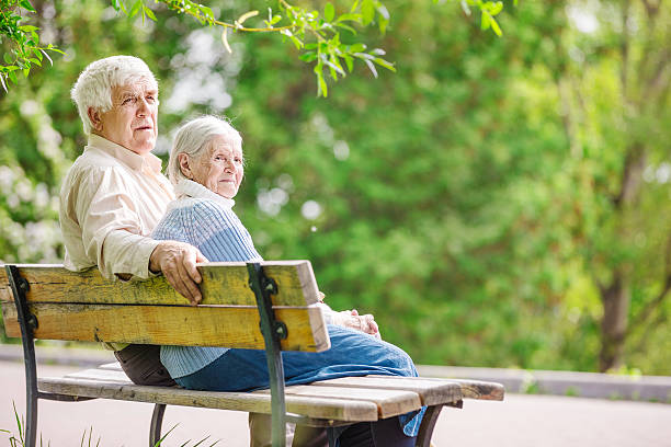 istock Elderly couple on bench in park 601944424