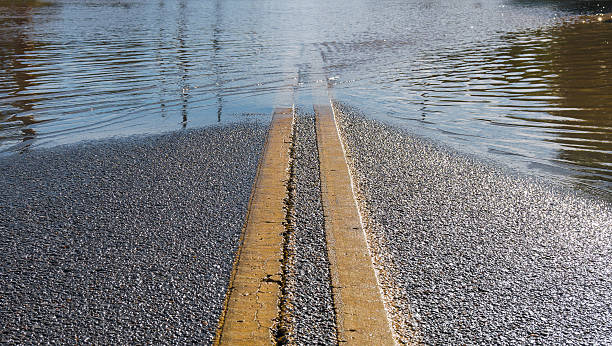istock Road Leading into Flooded Street 601945490