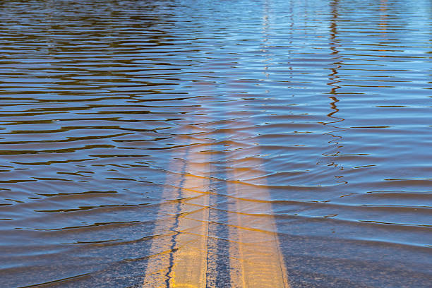 High Water Street Flooding Closeup of high water flooding on neighborhood street. weather warning sign stock pictures, royalty-free photos & images