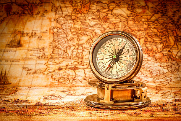 istock Vintage compass lies on an ancient world map. 601947500