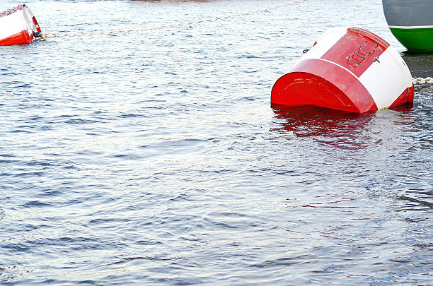 istock Red and white metal mooring buoys. 601948220