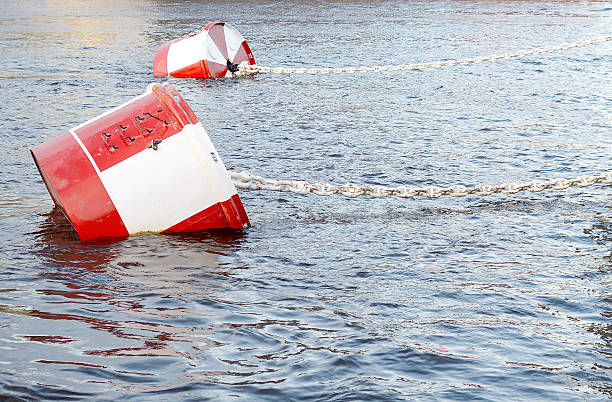 istock Red and white metal mooring buoys. 601948450