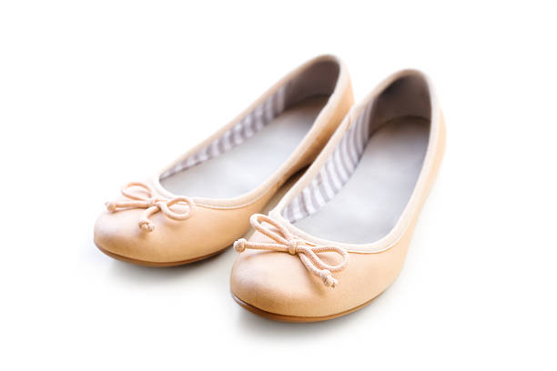 Beige ballet flats Beige ballet flats on the white background flat shoe stock pictures, royalty-free photos & images