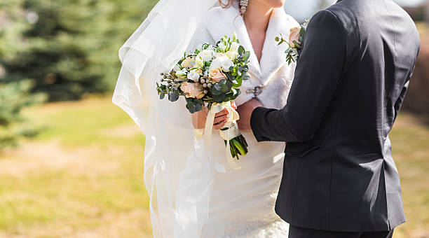 istock Bride and groom embracing on their wedding day close-up 601948672