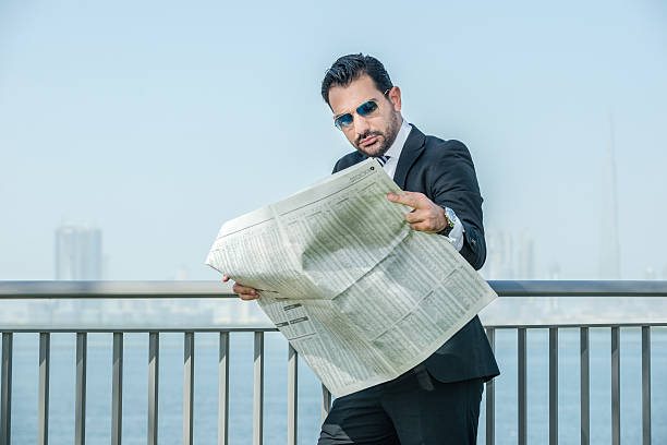 istock Confident Arab businessman reading a financial newspaper on the 602288268
