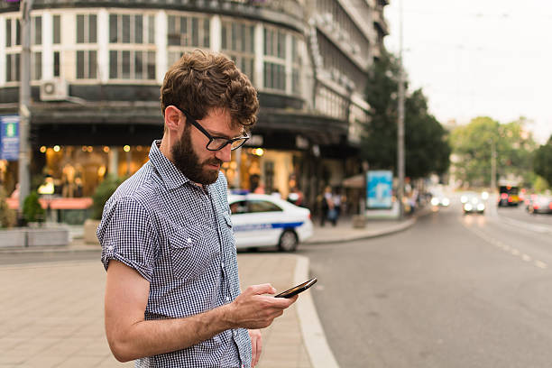 istock Young man using phone on the street 602289392