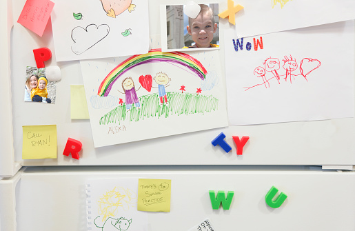 Fridge covered in family pictures and artwork