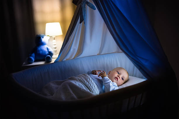 istock Adorable baby boy sleeping at night 602290858