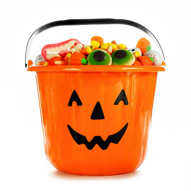 Halloween Jack-o-Lantern candy collector filled with candy over white