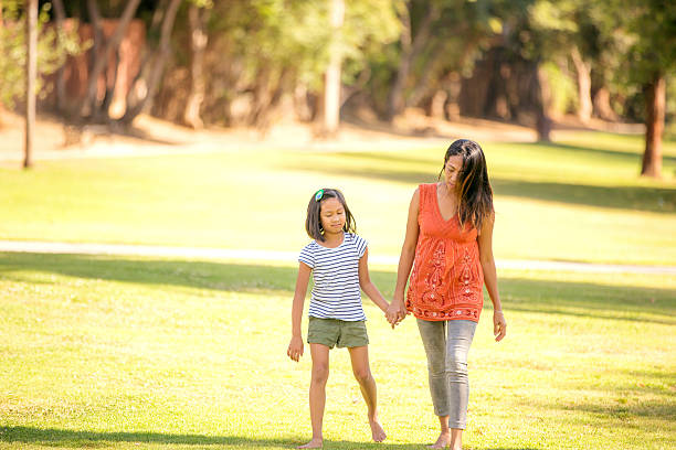 istock Young ethnic mother holding hands with her daughter 602294038