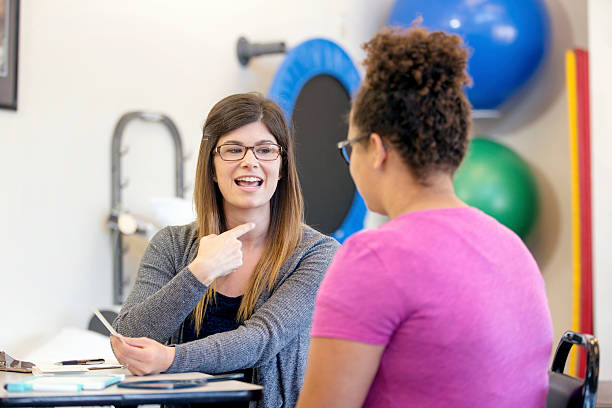 istock Young female speech therapist helping a female patient 602294564
