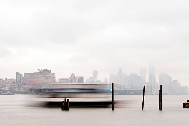 Ferry coming in for docking on a foggy day. New York, United States - June 2, 2015: East River Ferry coming in for docking on a foggy day. ny waterway ferry stock pictures, royalty-free photos & images