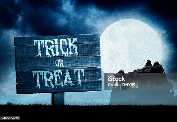 Trick Or Treat Sign In Front Of Haunted House Stock Photo - Download Image Now - Full Moon, Hanging, Horizon