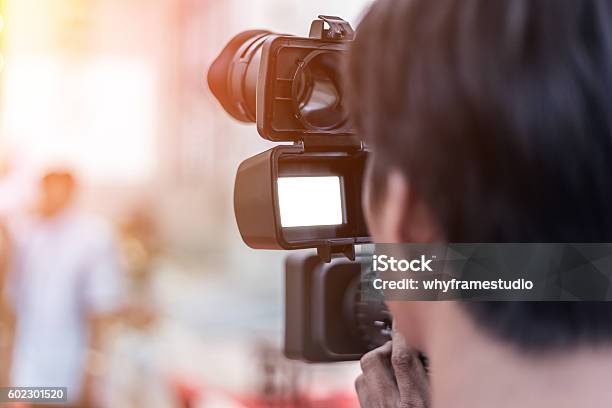 Videographer Takes Video Camera Stock Photo - Download Image Now - Adult, Arts Culture and Entertainment, Business