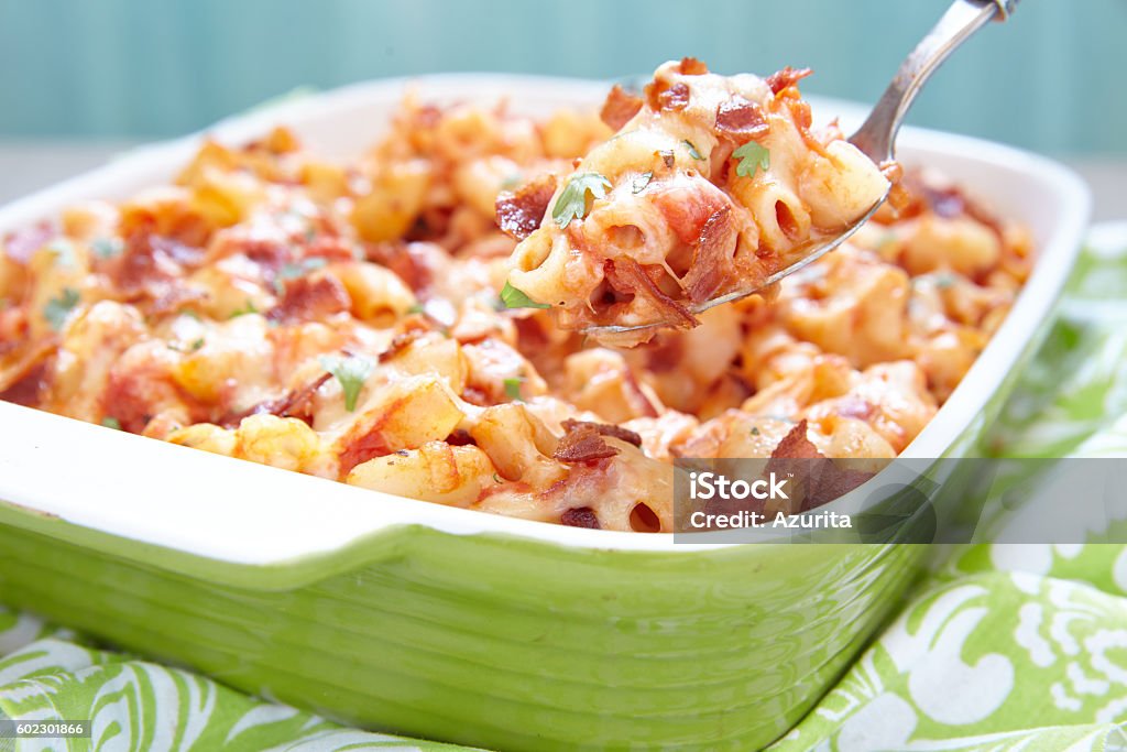 Pasta casserole with bacon, ham, cheese and tomato Pasta casserole with bacon, ham, cheese and tomato sauce Baked Stock Photo