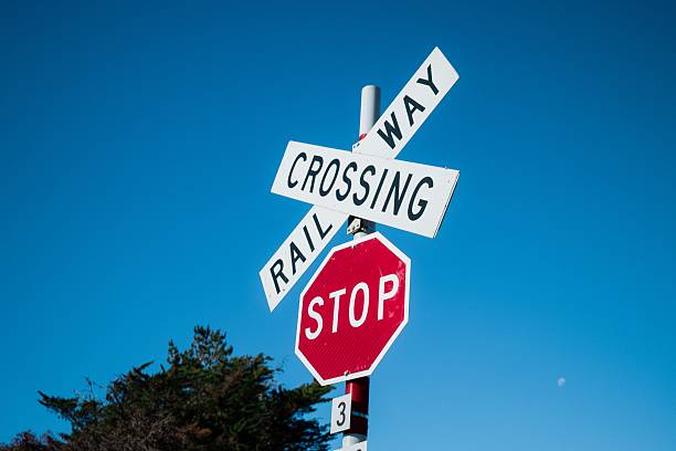 istock Railway Crossing and Stop Sign in Front of Blue Sky 602302110