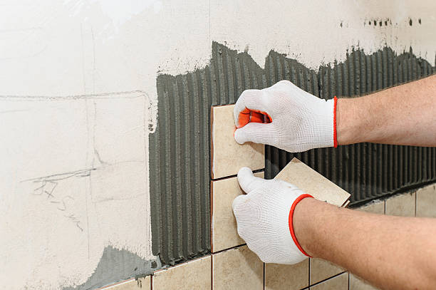 istock Worker  putting  tiles on the wall in the kitchen. 602302118