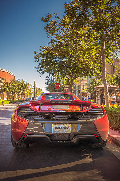 Rancho Cucamonga, USA - September 11, 2016: New McLaren 650S Coupe supercar crouches before a stop sign amidst shoppers at California outdoor mall.    