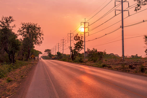 istock Electric pole on sunset along the road 602303222