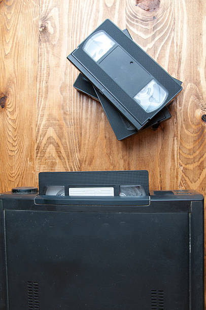 istock Equipment for playing VHS tapes on a wooden table 602304500